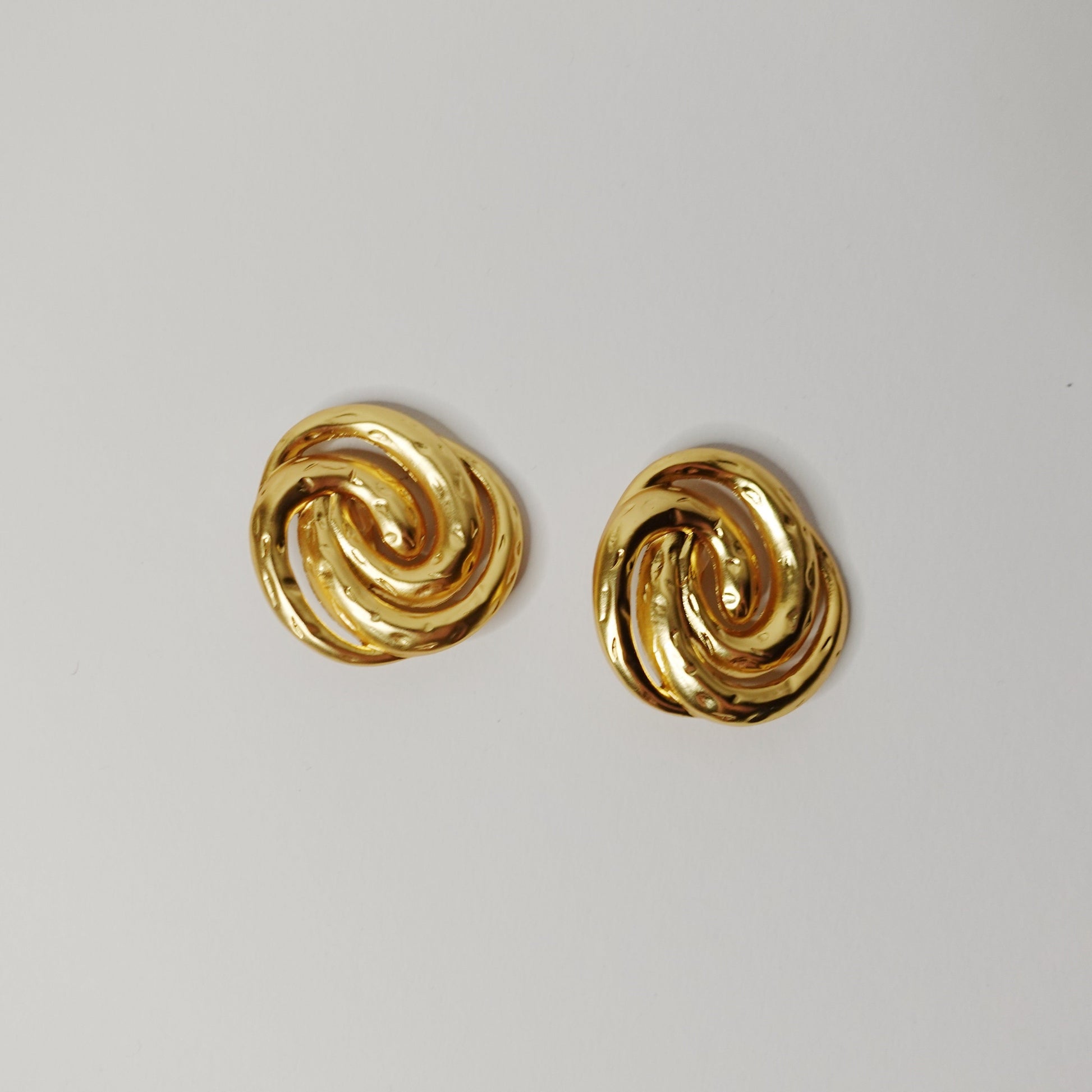 Fé Maria earrings gold vintage on studio backdrop